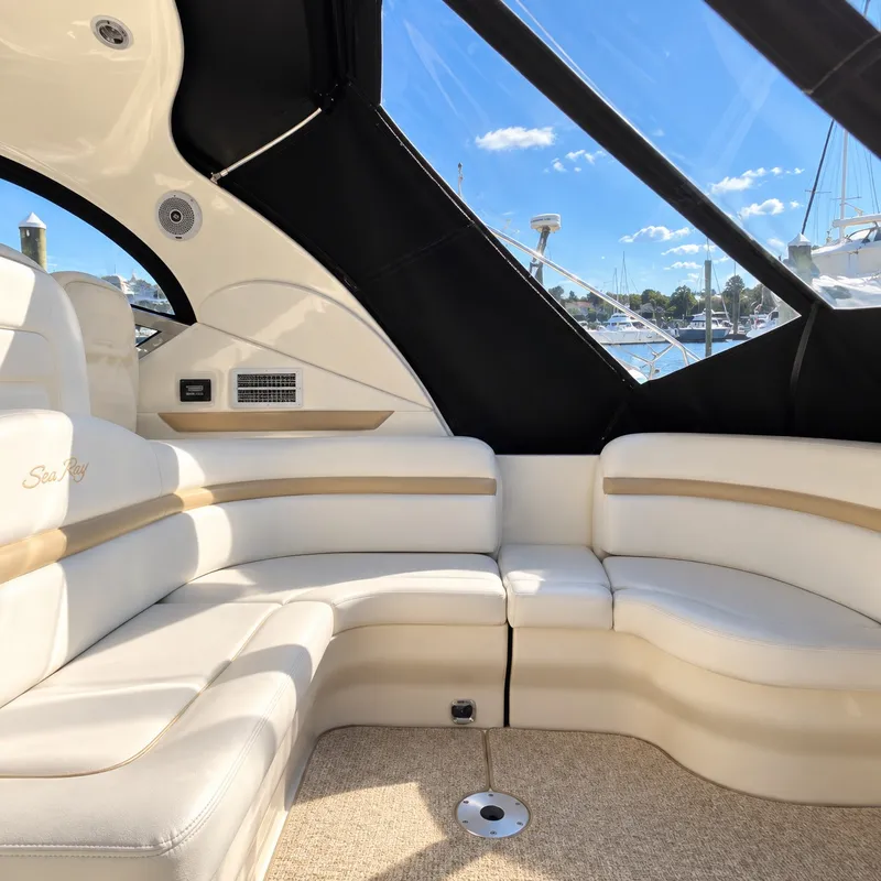 Slide: The Image of Interior of a 2010 Sea Ray 390 Sundancer with elegant cream seating and large windows. - 15