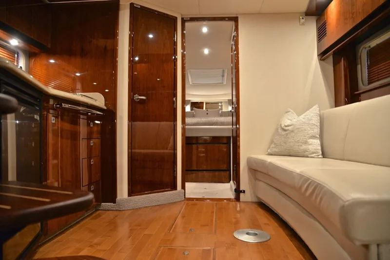 Slide: The Image of Interior of the 2010 Sea Ray 390 Sundancer with elegant wood furnishings and comfortable seating. - 25