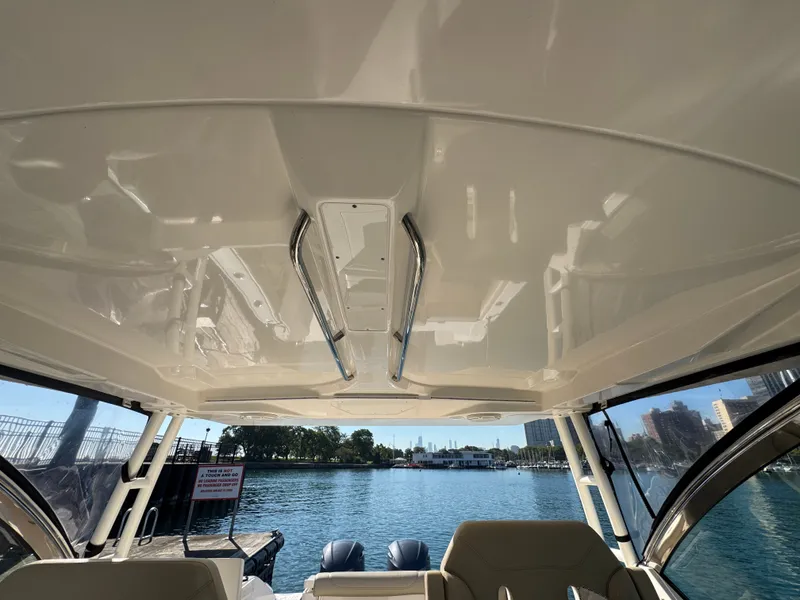 Slide: The Image of Interior view of a Pursuit DC 325 Dual Console overlooking the water. - 17