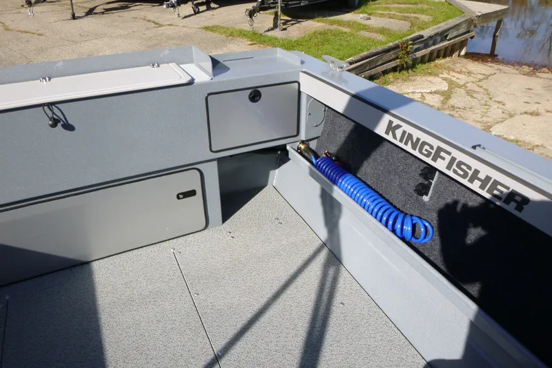 Slide: The Image of Interior of 2027 KingFisher 2025 Escape boat with storage compartments and coiled blue hose. - 20