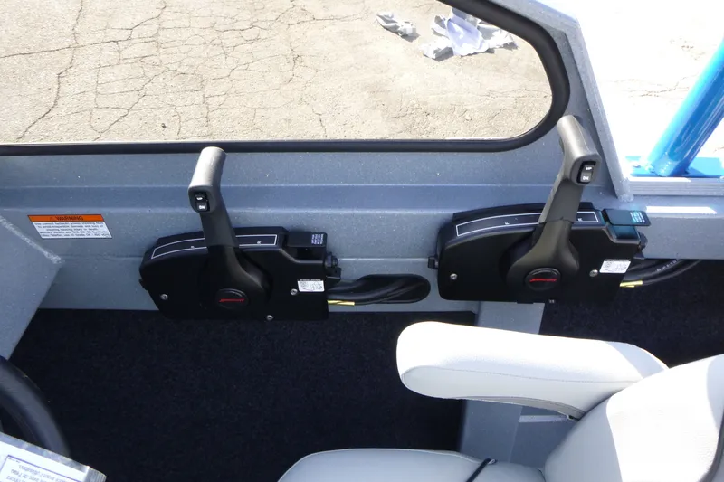 Slide: The Image of Dual throttle controls in a 2027 KingFisher 2025 Escape boat cockpit. - 19