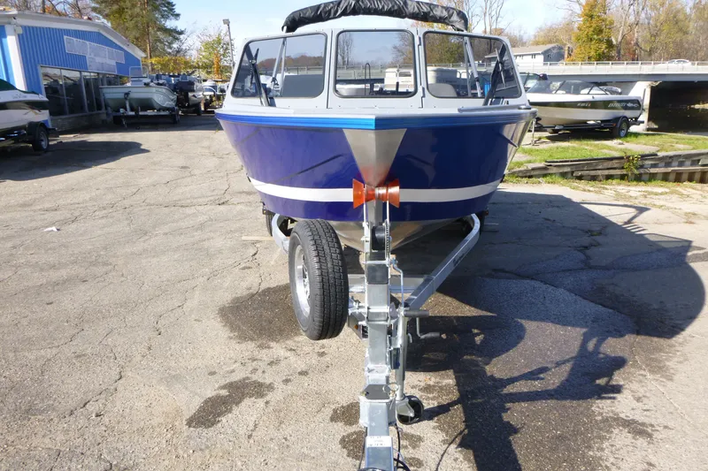 Slide: The Image of Blue 2027 KingFisher 2025 Escape boat on trailer in outdoor dealership lot. - 6