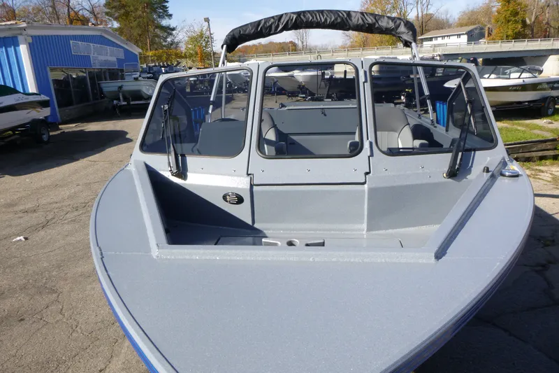 Slide: The Image of Front view of a 2027 KingFisher 2025 Escape boat in a marina setting. - 7