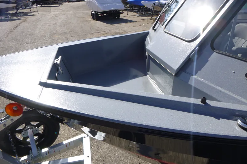 Slide: The Image of KingFisher 2025 Escape HT boat, 2027 model, parked on a trailer in a lot. - 9