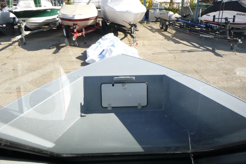 Slide: The Image of Bow view of a 2027 KingFisher 2025 Escape HT boat in a storage yard. - 12