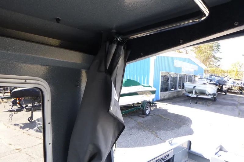 Slide: The Image of Interior view of KingFisher 2025 Escape HT boat, showcasing window and curtain detail. - 21