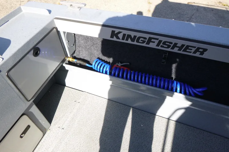 Slide: The Image of Interior of KingFisher 2025 Escape HT boat, featuring storage compartment with coiled blue hose. - 28