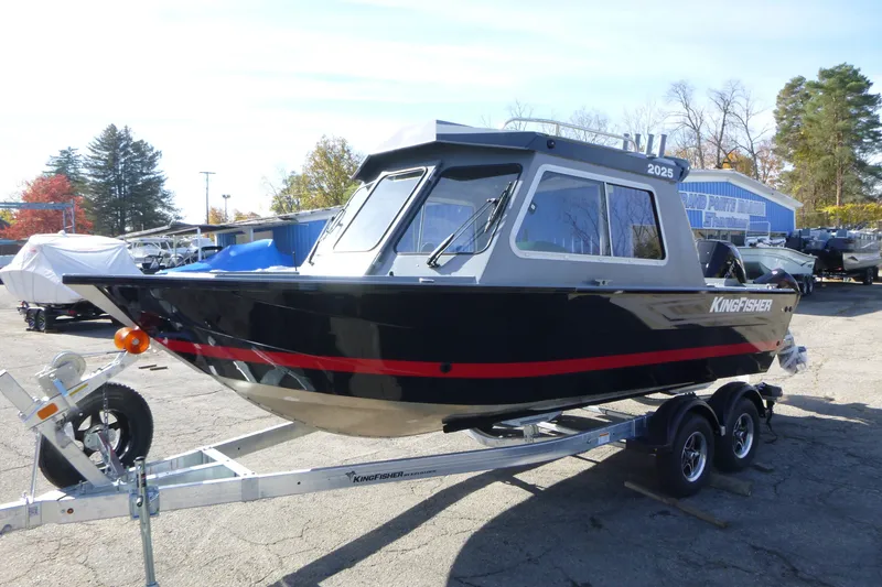 Slide: The Image of 2027 KingFisher 2025 Escape HT boat on trailer, outdoor dealership setting. - 7