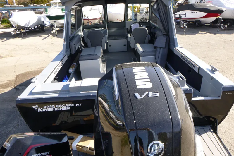 Slide: The Image of KingFisher 2025 Escape HT boat with Mercury V6 engine, docked outdoors. - 4