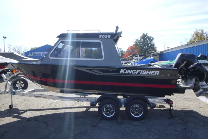 Slide: The Image of KingFisher 2025 Escape HT boat on trailer, side view, outdoors, sunny day. - 6