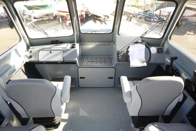 Slide: The Image of Interior of 2027 KingFisher 2025 Escape HT boat, featuring modern seating and control panel. - 13