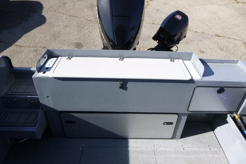 Slide: The Image of Interior view of 2027 KingFisher 2025 Escape HT boat with storage compartments and motor. - 26