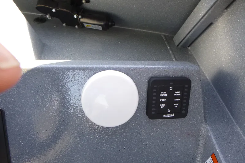 Slide: The Image of Control panel of KingFisher 2025 Escape HT boat, featuring buttons and a white circular component. - 17
