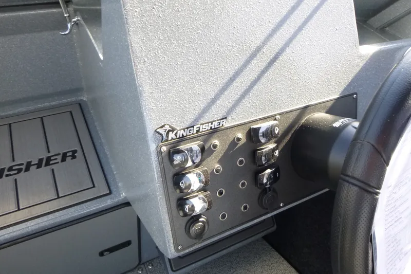 Slide: The Image of Control panel of KingFisher 2025 Escape HT boat, featuring switches and steering wheel. - 18