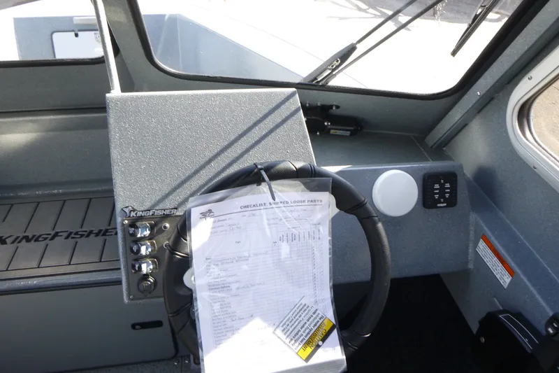 Slide: The Image of Interior of 2027 KingFisher 2025 Escape HT boat, featuring steering wheel and control panel. - 16