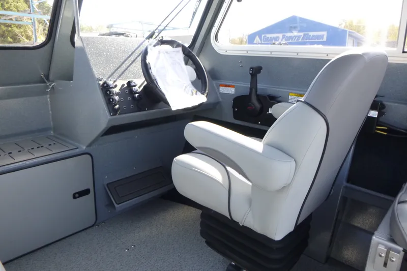 Slide: The Image of Interior of 2027 KingFisher 2025 Escape HT boat with steering wheel and captain's chair. - 15