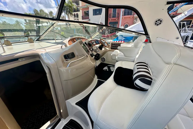 Slide: The Image of Interior of 2001 Sea Ray Sundancer 460 yacht with plush seating and modern controls. - 18
