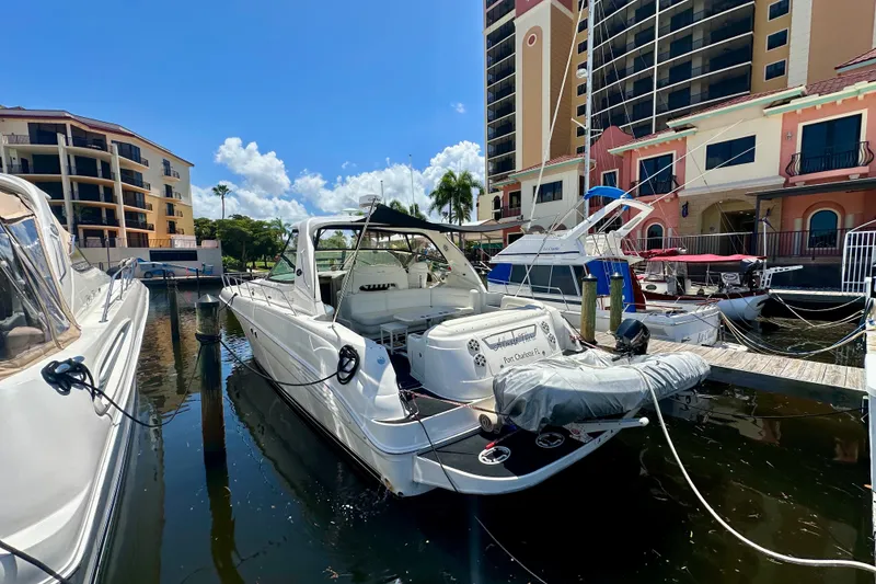 The Image of 2001 Sea Ray Sundancer 460 yacht docked at marina with buildings in background. - 7