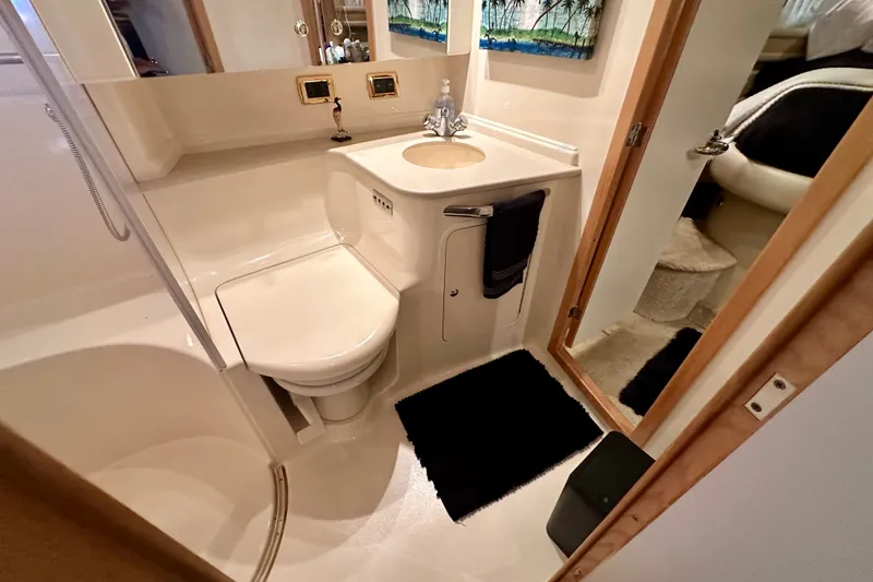 Slide: The Image of Bathroom interior of 2001 Sea Ray Sundancer 460 yacht, featuring toilet and sink. - 34