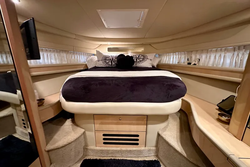 Slide: The Image of Luxurious cabin interior of 2001 Sea Ray Sundancer 460 yacht with cozy bed and elegant decor. - 22