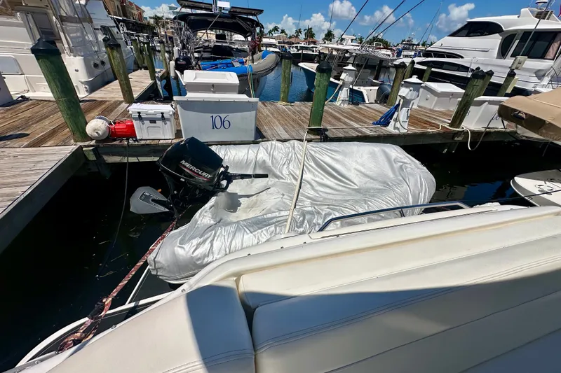 Slide: The Image of Docked Sea Ray Sundancer 460 yacht with covered dinghy and Mercury outboard motor. - 8