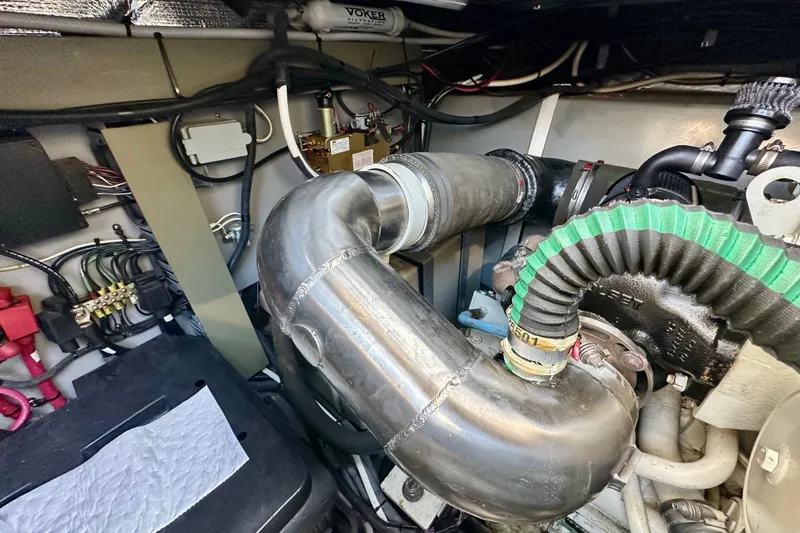 Slide: The Image of Engine room of a 2001 Sea Ray Sundancer 460, showcasing pipes and mechanical components. - 37