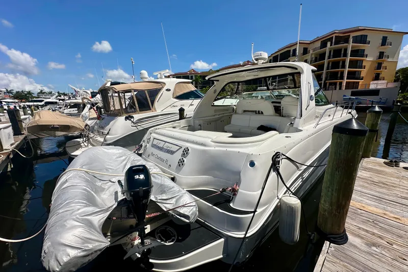 Slide: The Image of 2001 Sea Ray Sundancer 460 yacht docked at marina under clear blue sky. - 5