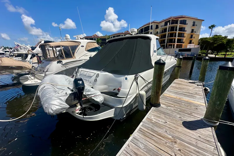 Slide: The Image of 2001 Sea Ray Sundancer 460 yacht docked at marina under clear blue sky. - 0