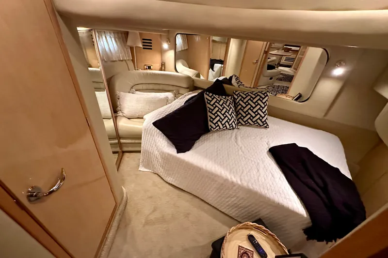 Slide: The Image of Luxurious cabin interior of 2001 Sea Ray Sundancer 460 yacht with cozy bed and elegant decor. - 26