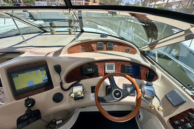 Slide: The Image of Cockpit of 2001 Sea Ray Sundancer 460 with navigation equipment and wooden steering wheel. - 16