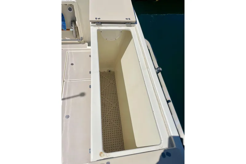 Slide: The Image of Open storage compartment on a 2001 Albin 28 Tournament Express boat. - 18