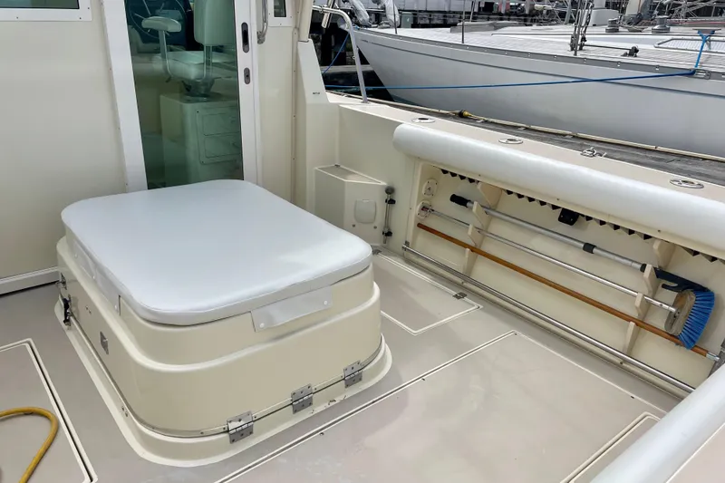 Slide: The Image of 2001 Albin 28 Tournament Express boat interior with seating and storage compartments. - 14