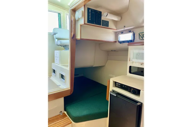 Slide: The Image of Interior of 2001 Albin 28 Tournament Express boat with seating and compact kitchenette. - 21