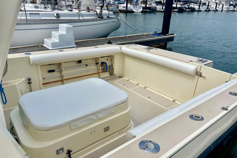 Slide: The Image of 2001 Albin 28 Tournament Express boat interior at marina, featuring seating and storage. - 15