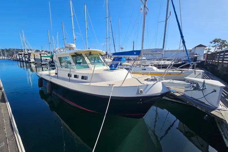 The Image of 2001 Albin 28 Tournament Express docked at a marina, surrounded by sailboats. - 0