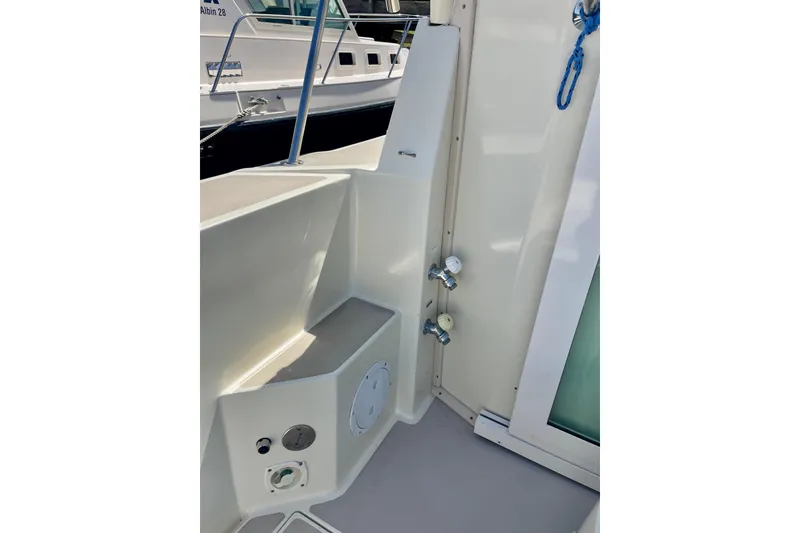 Slide: The Image of 2001 Albin 28 Tournament Express boat interior with utility fixtures and storage compartment. - 23