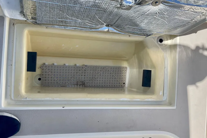Slide: The Image of Open storage compartment on a 2001 Albin 28 Tournament Express boat. - 22