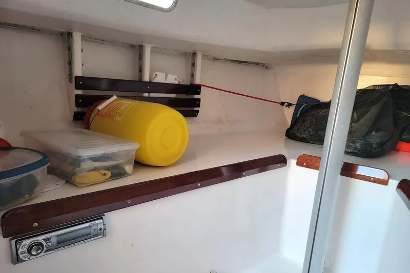 Slide: The Image of Interior of 2006 Ensign 23 sailboat with storage items and equipment. - 23