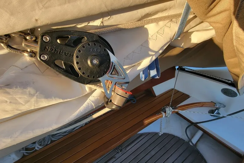Slide: The Image of Close-up of sailing equipment on a 2006 Ensign 23 sailboat, featuring Harken block and tackle. - 25