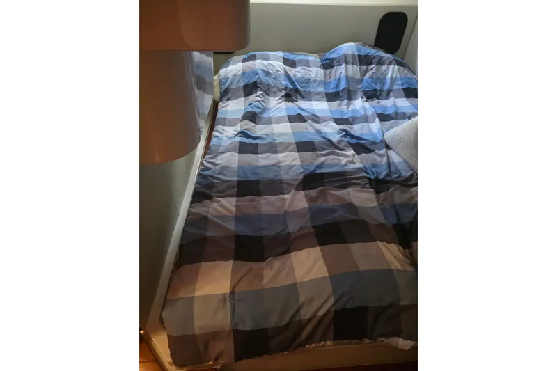 Slide: The Image of Cozy bed with blue plaid bedding inside a 2015 Pursuit SC 365i Sport Coupe. - 20