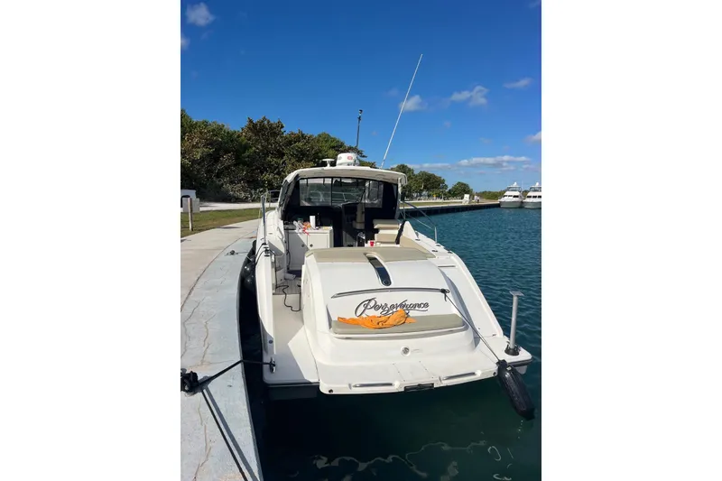 Slide: The Image of 2015 Pursuit SC 365i Sport Coupe docked at marina under clear blue sky. - 23