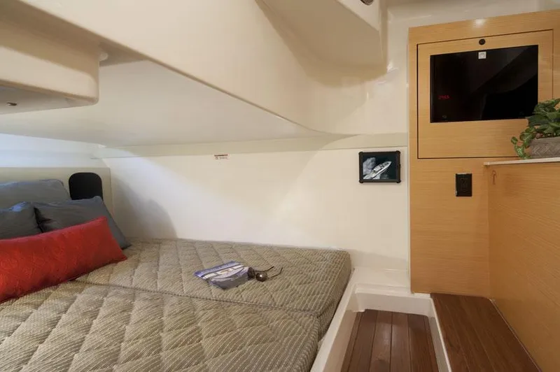 Slide: The Image of Manufacturer Provided Image: Interior cabin of 2015 Pursuit SC 365i Sport Coupe with bed and wooden cabinetry. - 18