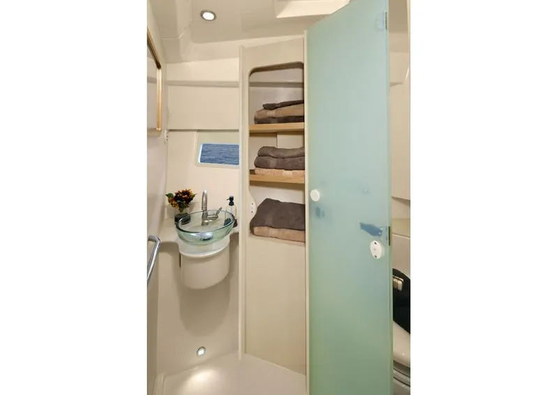 Slide: The Image of Manufacturer Provided Image: 2015 Pursuit SC 365i Sport Coupe bathroom with glass sink and towel storage. - 19