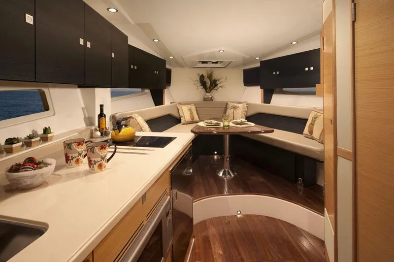 Slide: The Image of Manufacturer Provided Image: Interior of 2015 Pursuit SC 365i Sport Coupe with modern kitchen and cozy seating area. - 15