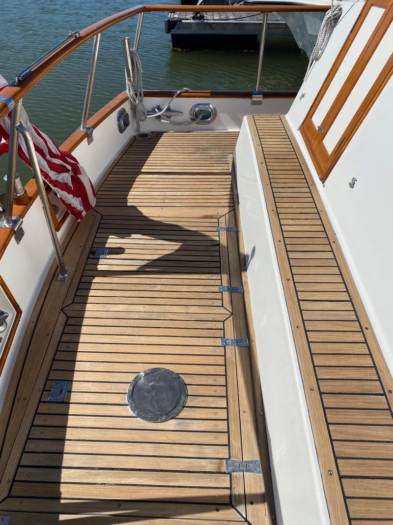 Slide: The Image of 1997 Grand Banks Classic yacht with teak deck and American flag. - 43