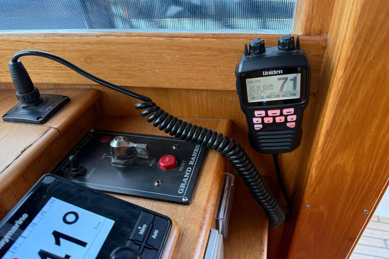 Slide: The Image of 1997 Grand Banks Classic boat dashboard with Uniden radio and control panel. - 19