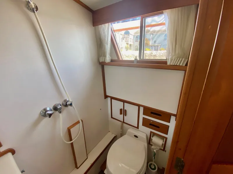 Slide: The Image of Bathroom interior of 1997 Grand Banks Classic yacht, featuring shower and toilet. - 37