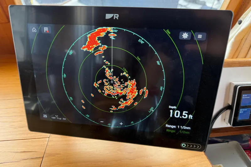 Slide: The Image of Radar display on 1997 Grand Banks Classic boat showing depth and range data. - 15
