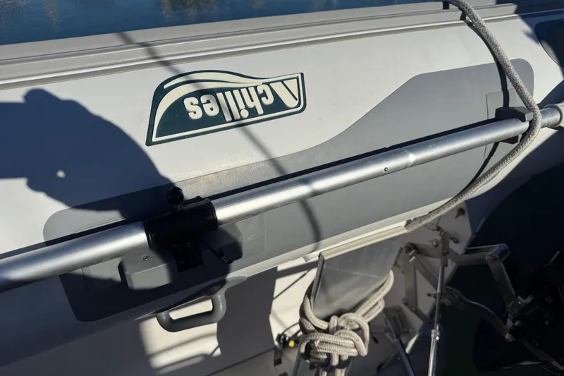 Slide: The Image of Close-up of a 1997 Grand Banks Classic boat with a dinghy and ropes. - 62