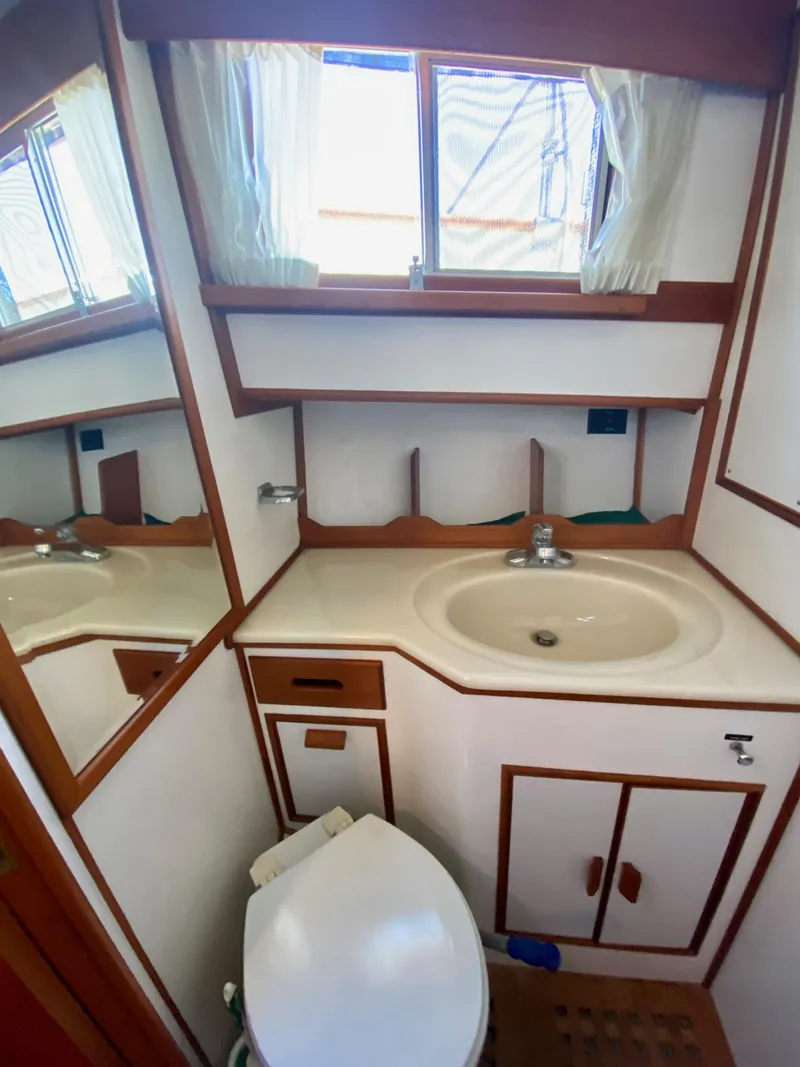 Slide: The Image of 1997 Grand Banks Classic yacht bathroom with sink, mirror, and toilet. - 40